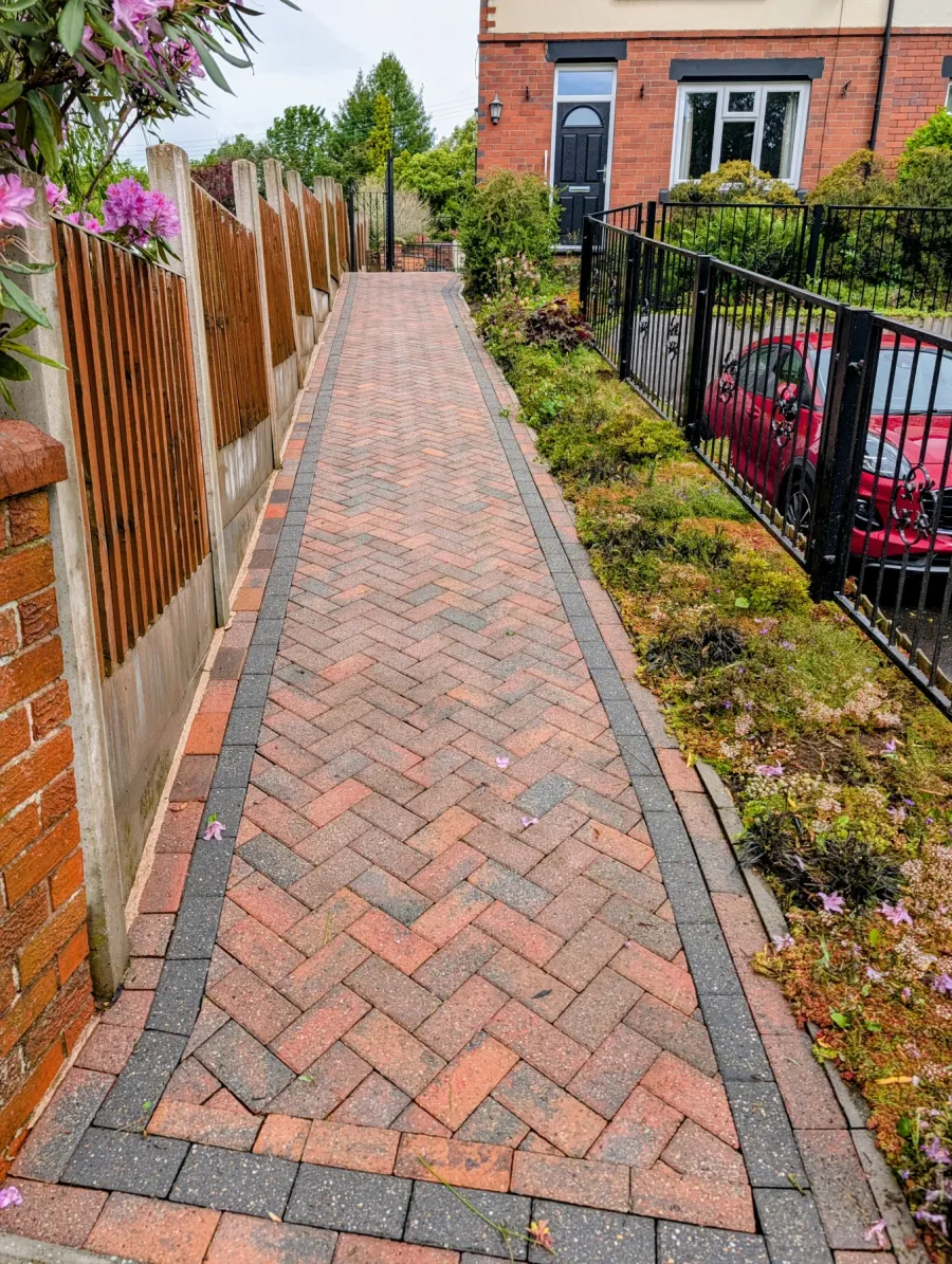 The same long block-paved garden path after cleaning