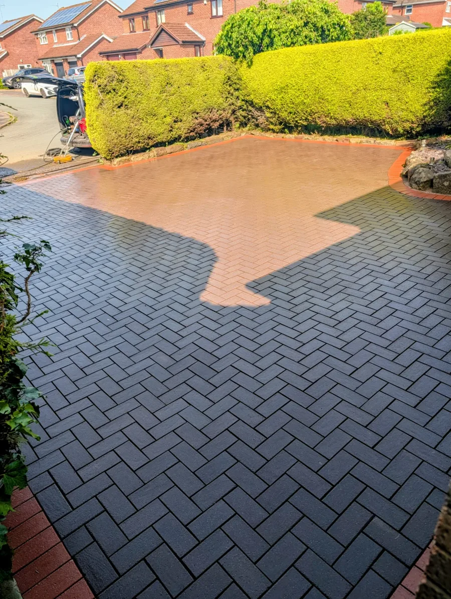 The same large block-paved driveway after cleaning