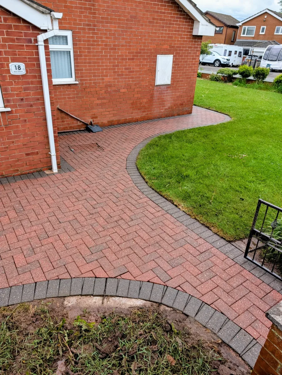 The same block-paved path around a house after cleaning