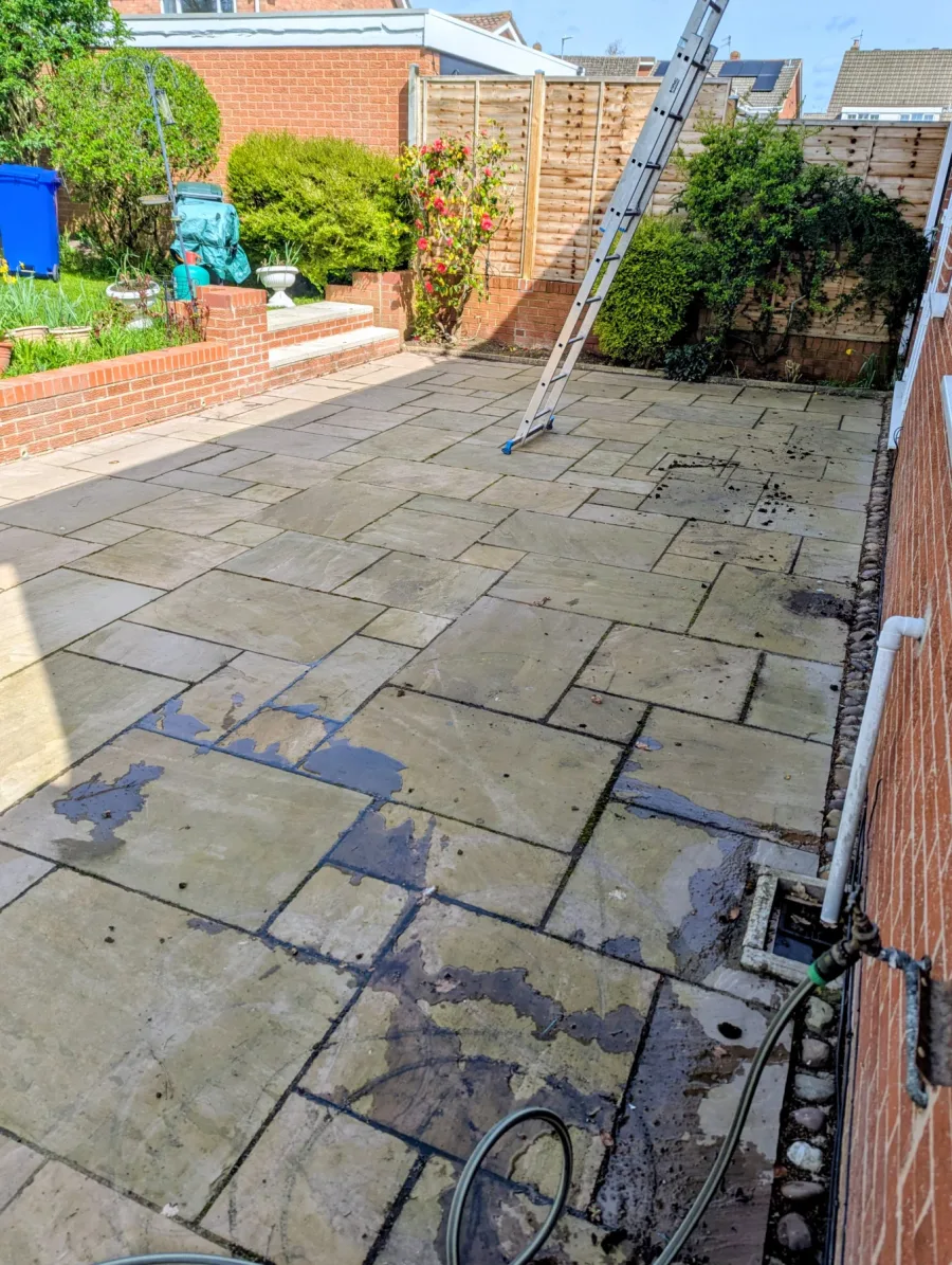 A slab-paved patio before its clean was completed