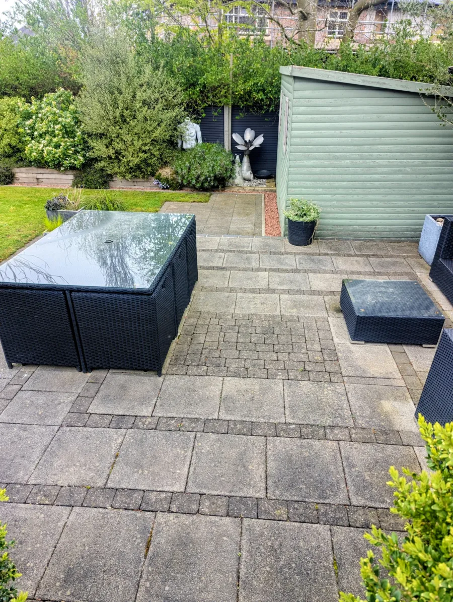 A patterned paved patio before cleaning