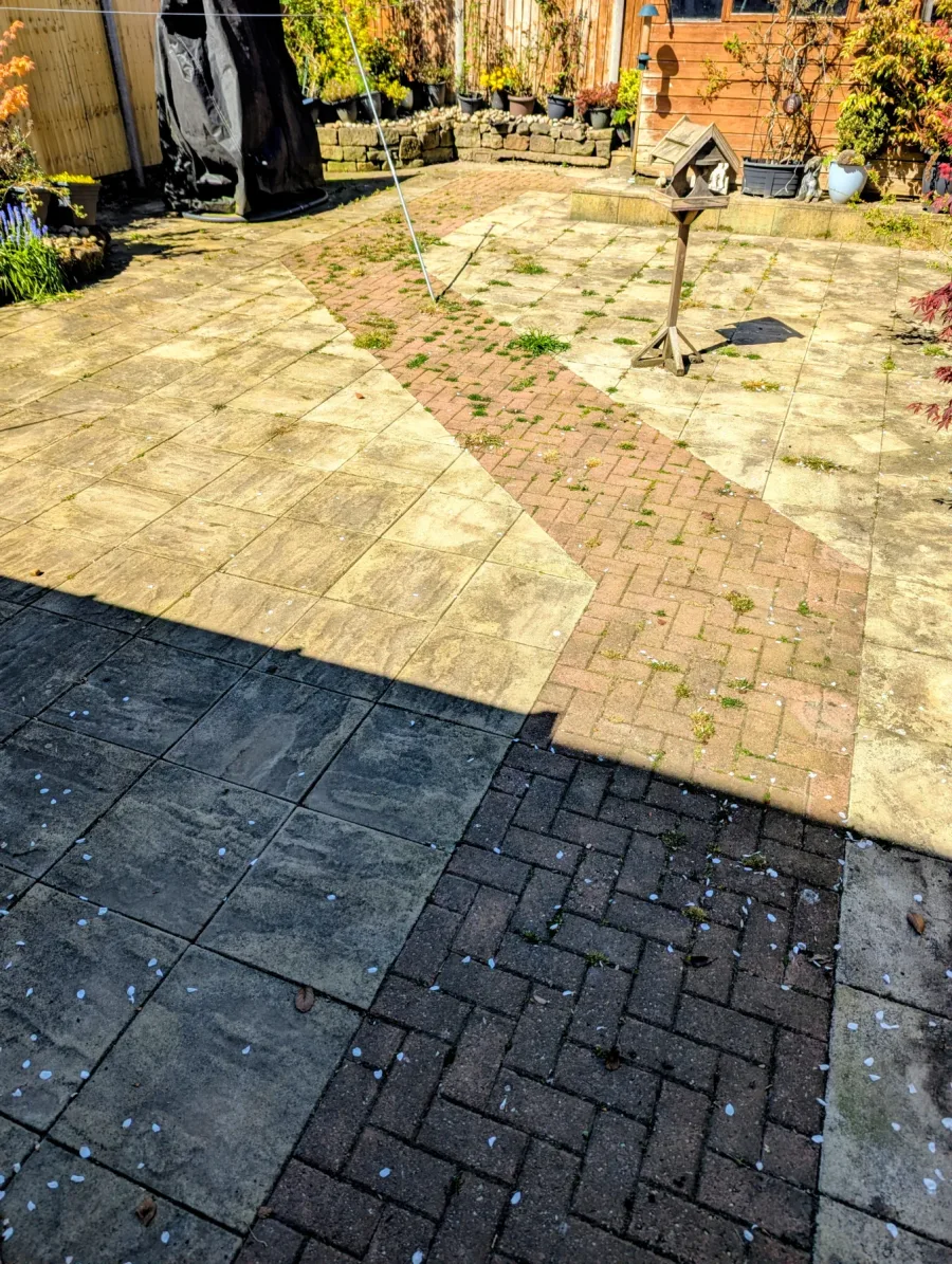 A large paved patio before cleaning
