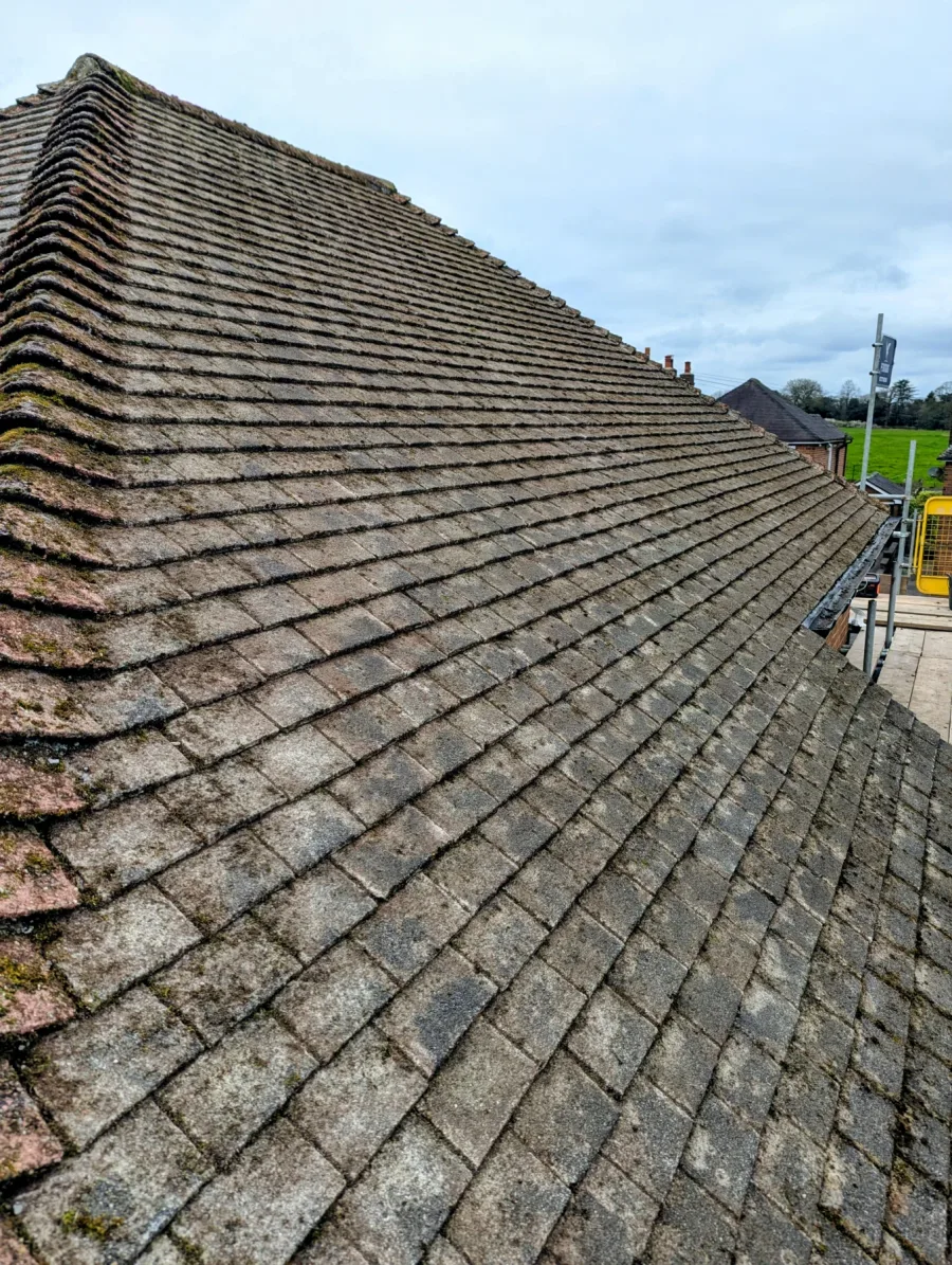 The same tiled roof after manual moss removal