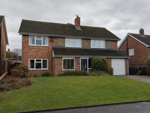Ground-level photograph showing the complete tiled roof of a UK house.