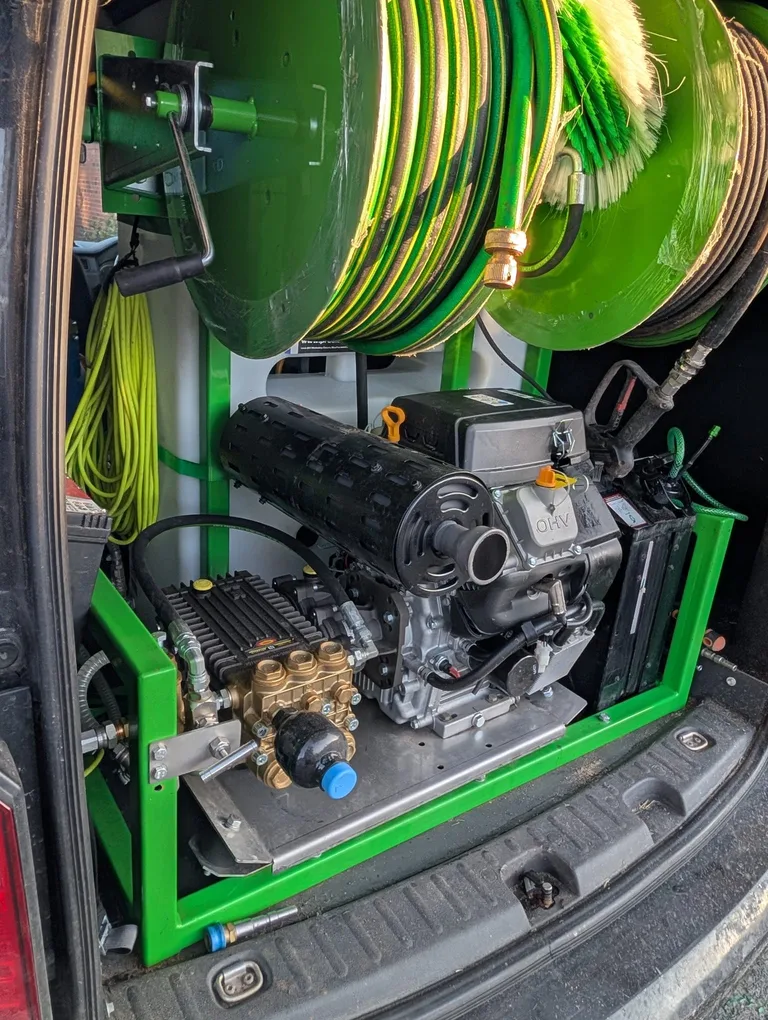 Angled view of the fitted pressure washer, hose reels and water tank inside the Tidy Van.