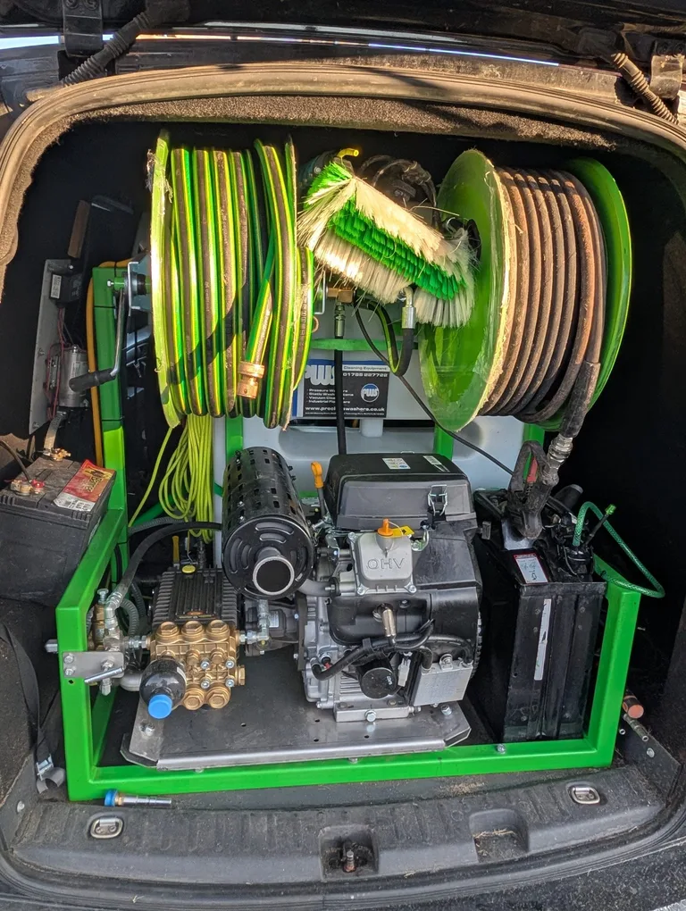 Wide rear view showing both hose reels and the pressure washer inside the Tidy Van.