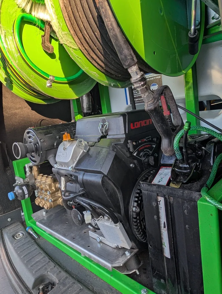 Side view of the fitted pressure washer and black hose reel inside the Tidy Van.