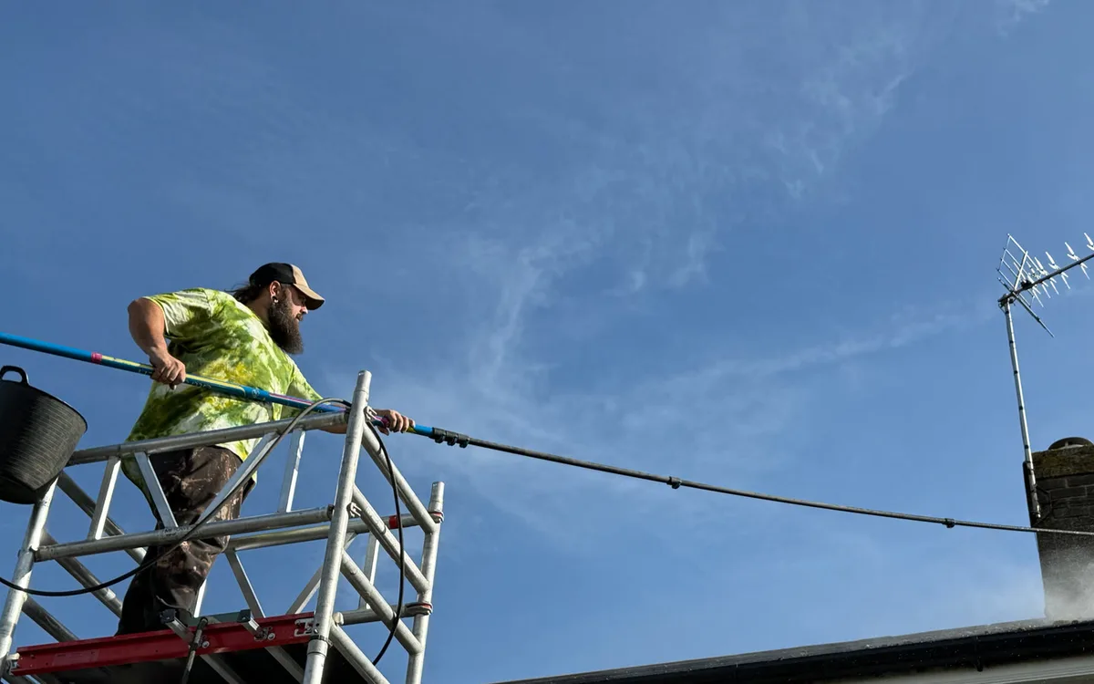 Mike cleaning the tiled roof from a mobile access tower at a residential property in Tean.